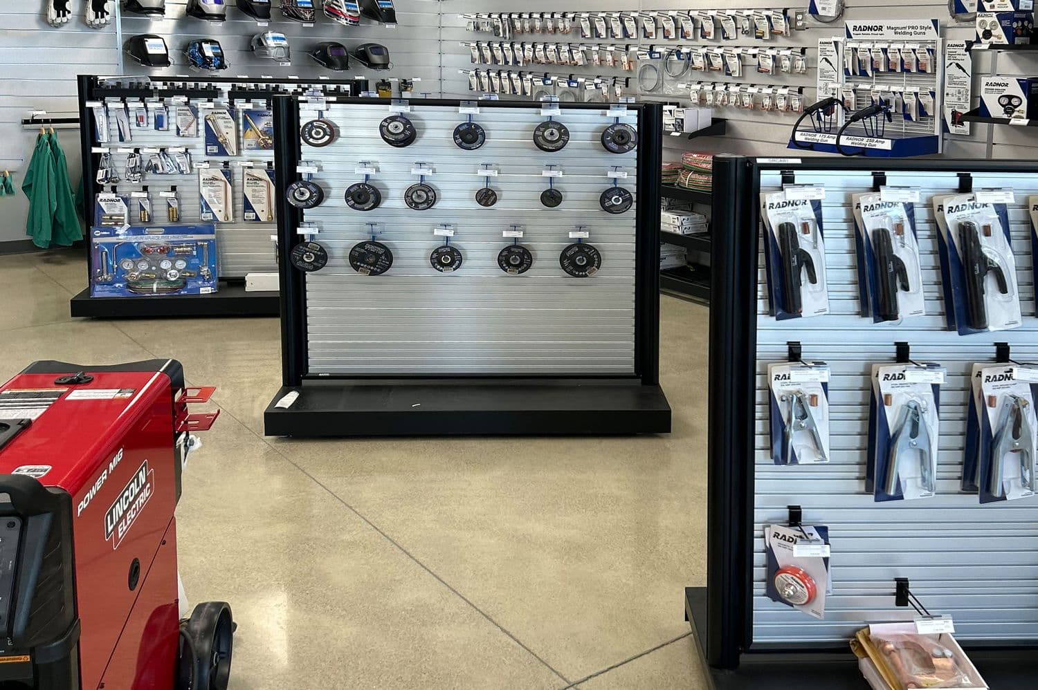 Mobile NeXtrac slatwall gondolas form product aisles inside an Airgas industrial supply store.