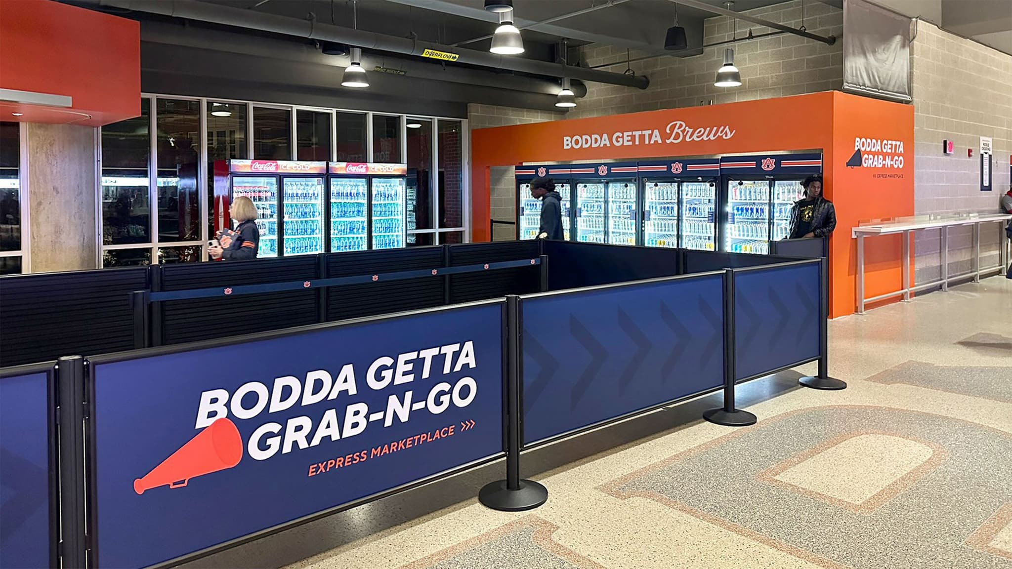 Partition posts with hinged frame panels define the Grab-N-Go concession queue at Auburn's Jordan-Hare Stadium.