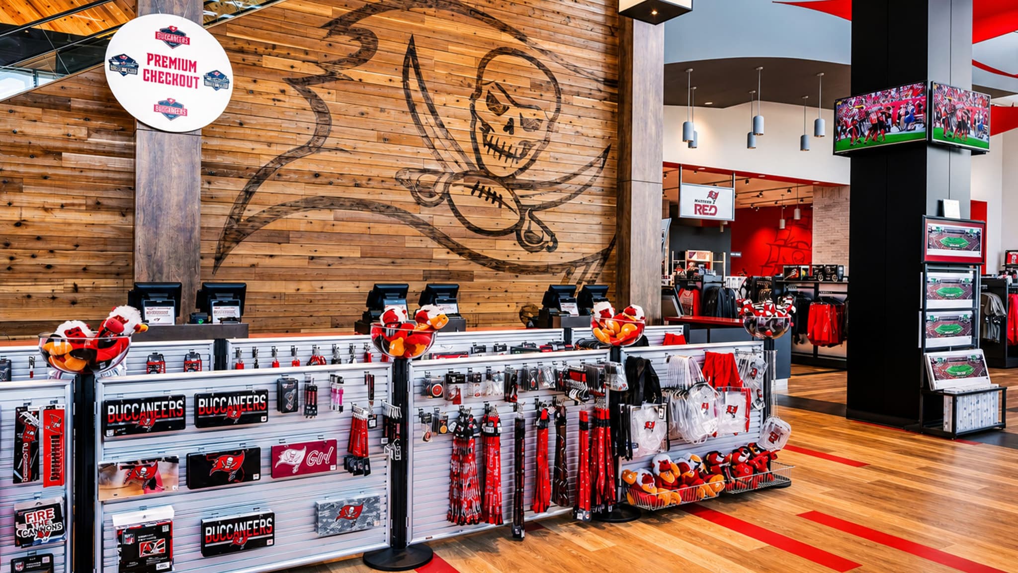 Beltrac retractable belt stanchions with slatwall displays merchandise the checkout queue in the Tampa Bay Buccaneers team store.