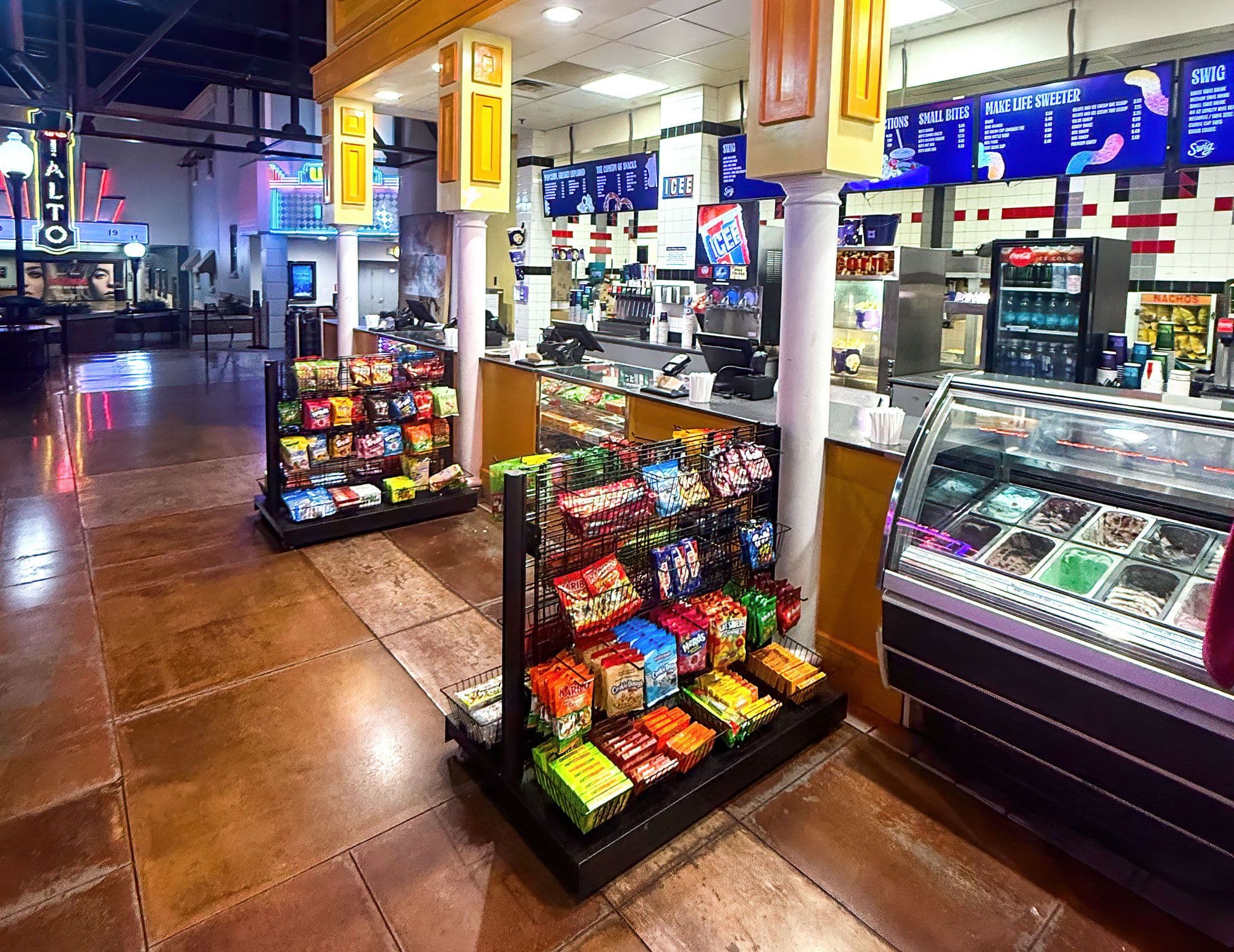 A NeXtrac gridwall gondola displays candy at the concession counter of a Megaplex theater.