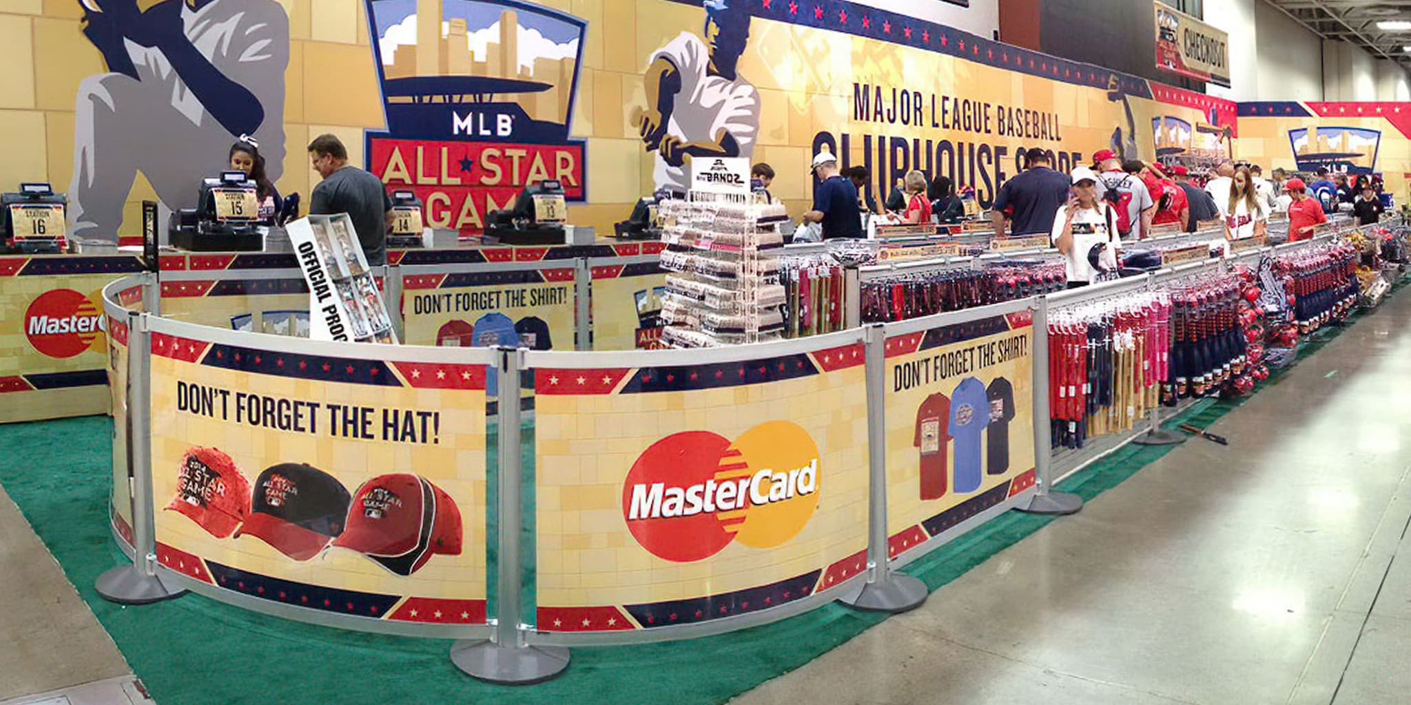 Post and Panel barriers with printed graphics and slatwall displays organize the checkout queue at an MLB team store.