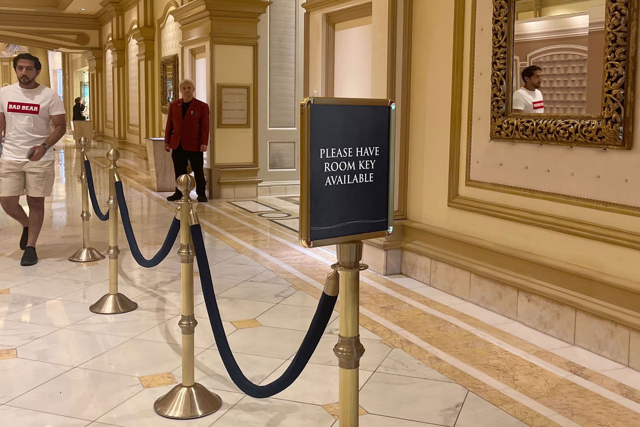 Post-Top Stanchion Sign in a hotel corridor
