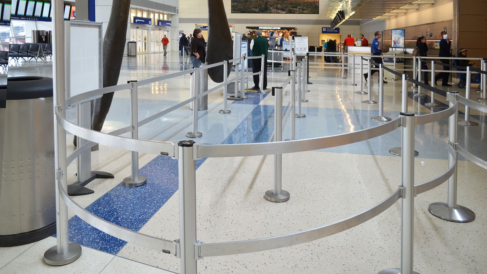 Double Rigid Rail barriers on partition posts form the security screening queue at Dallas Fort Worth International Airport.