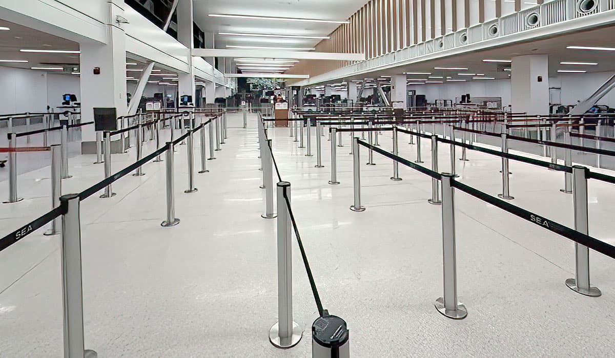 Beltrac retractable belt stanchions with blue belts form the security queue at Seattle-Tacoma International Airport.