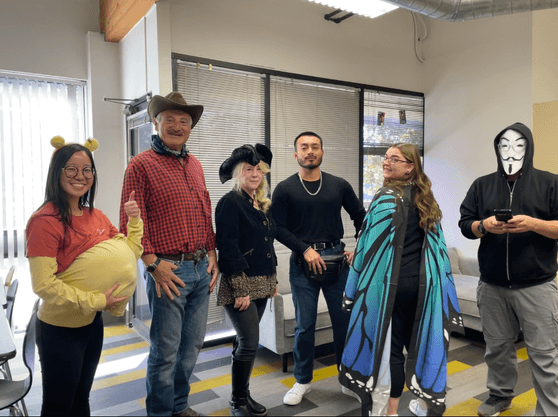 Lavi Industry employees in a row, showcasing their Halloween costumes
