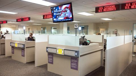 An electronic queuing system with LCD display and station lights at the Broward County Customs & Boarder Patrol