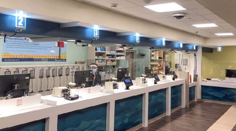 Electronic queuing system with ceiling mounted register lights at a Kaiser Pharmacy