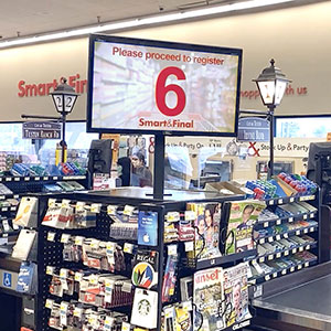 An electronic queuing system media display calls the next customer