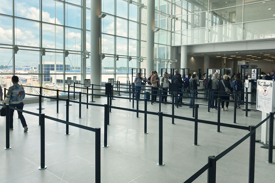Passengers waiting in airport security queue