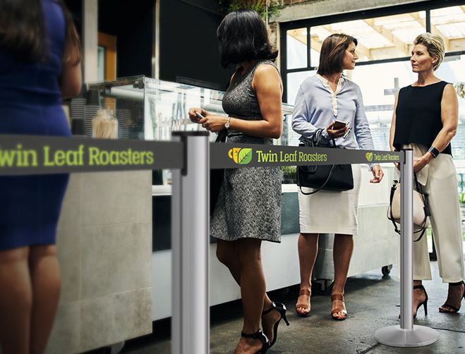 Several customers organized into a single line queue at Twin Leaf Roasters.