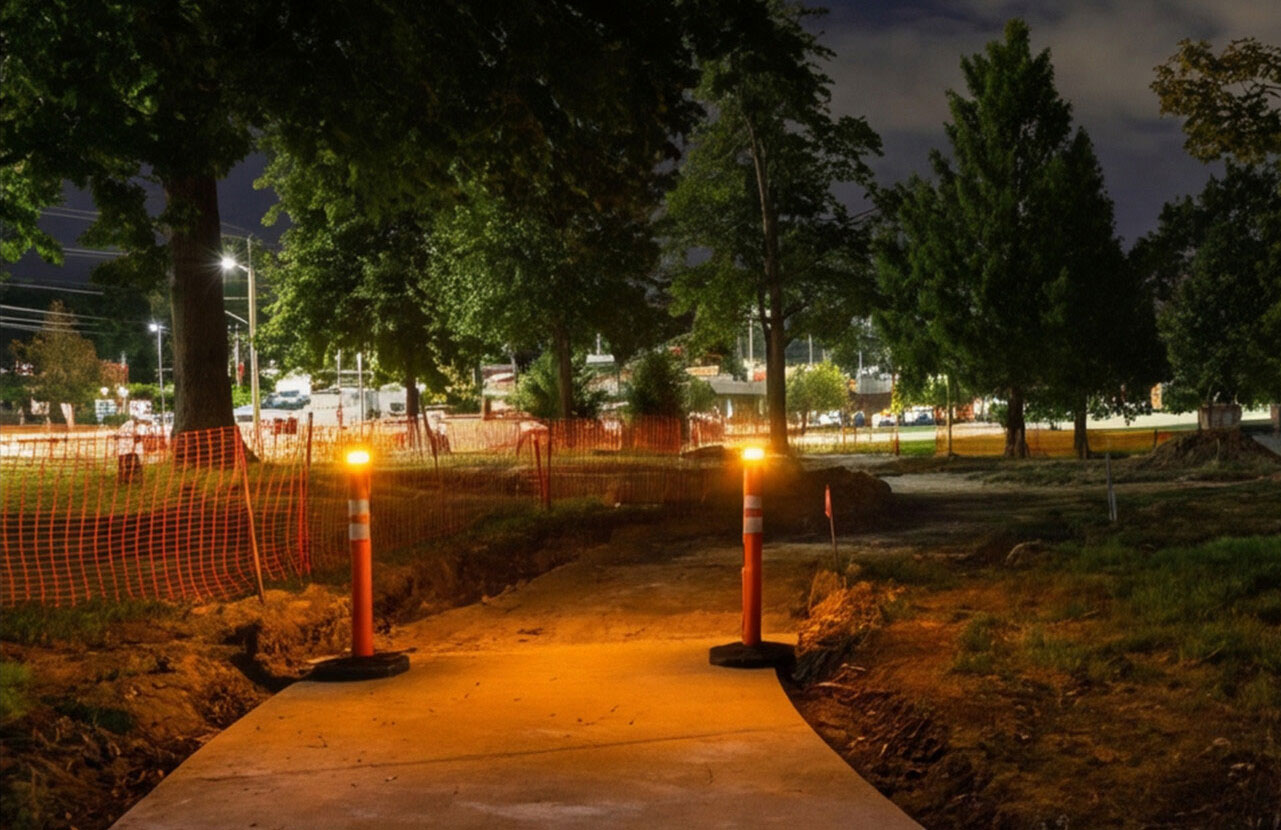Heavy Base Delineator with Solar Powered Light at night in a park construction zone
