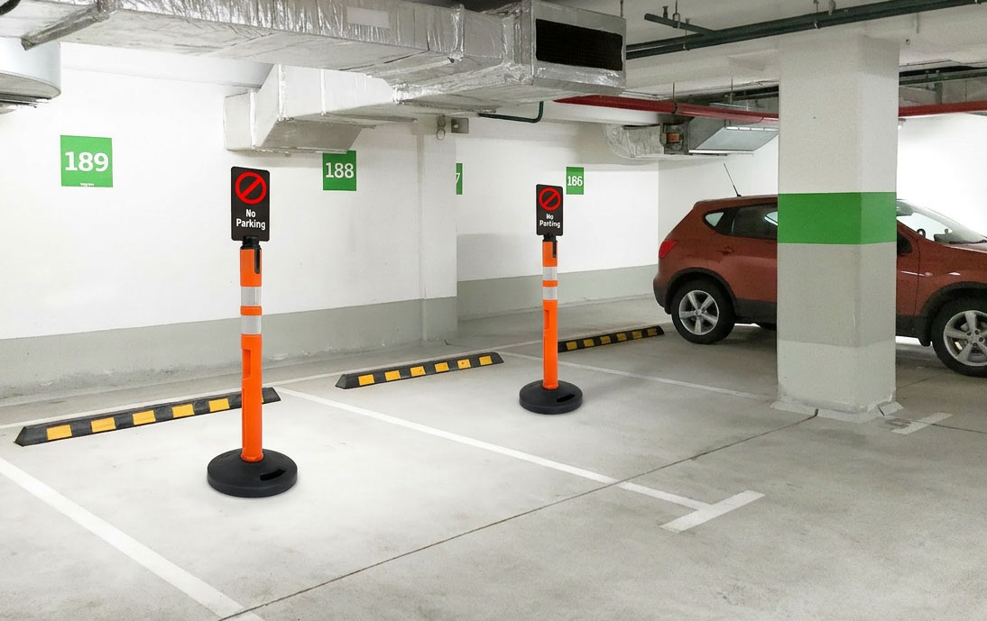 Delineator posts blocking spaces in a parking garage